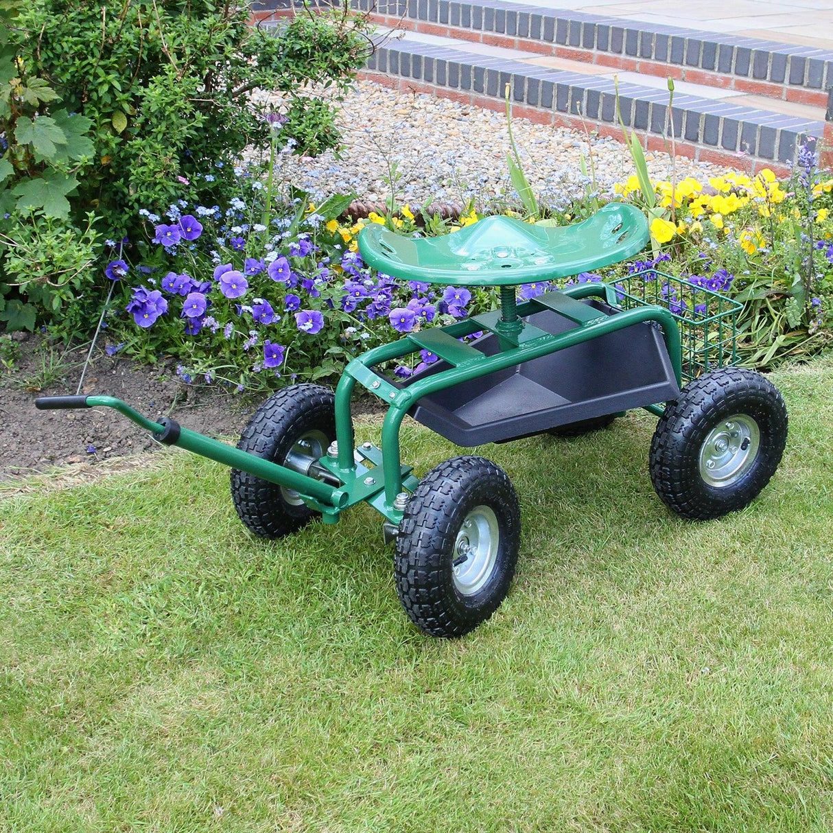Heavy-duty mobile garden seat with a green plastic seat, sturdy metal frame, large wheels, and a storage basket, set on grass with flowers in the background
