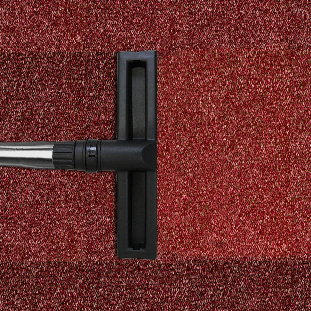 90L Maxblast Industrial Vacuum nozzle on red textured carpet, showcasing its wet and dry cleaning capabilities and sturdy design