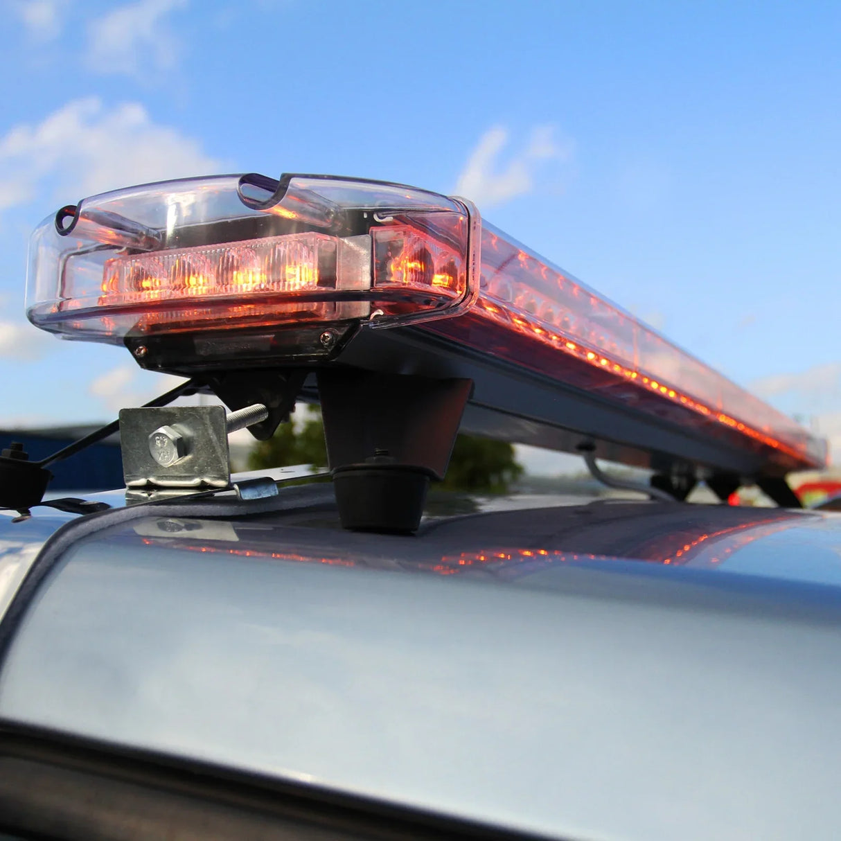 Amber Recovery Light 1200mm with bright amber LEDs, mounted on a vehicle roof, showcasing a sleek design against a blue sky
