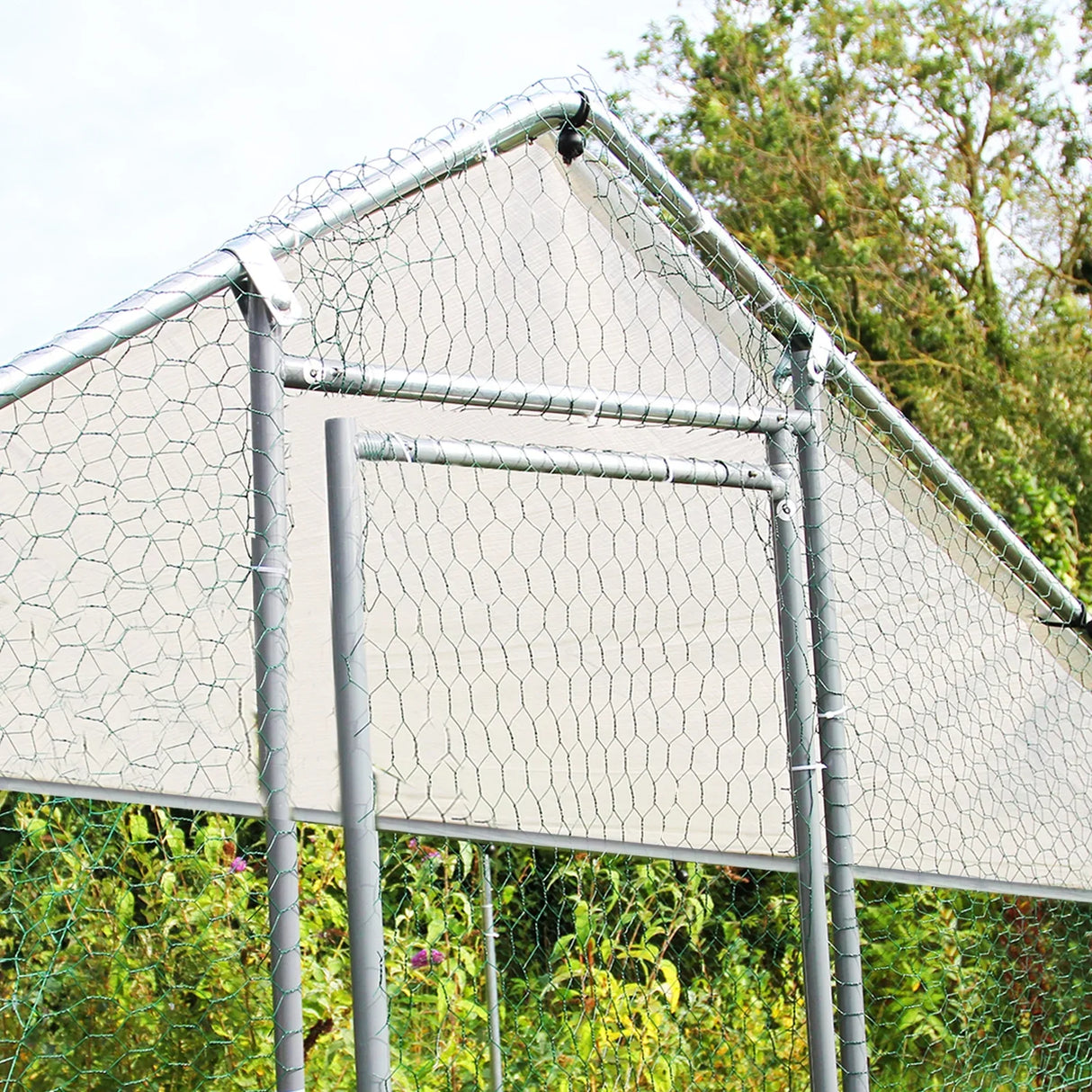 Durable chicken run measuring 4m x 6m x 2m with a sturdy metal frame, hexagonal wire mesh, and a sloped roof for protection
