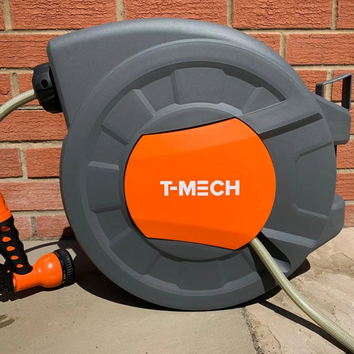 30m retractable hosepipe with a durable gray casing and bright orange T-MECH logo, featuring a flexible hose and ergonomic spray nozzle