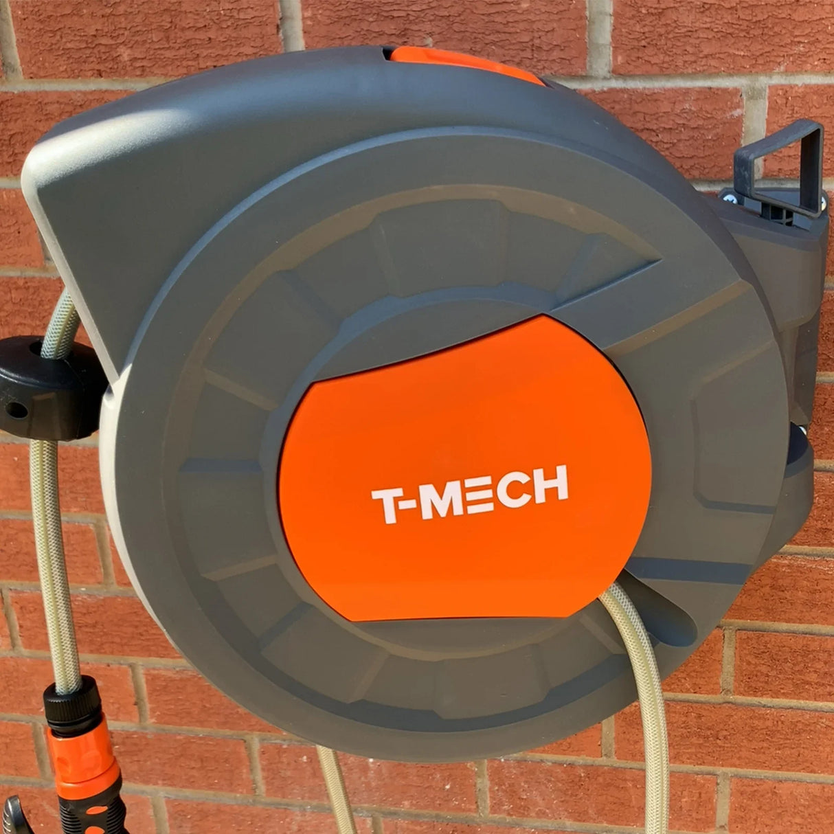 30m retractable hosepipe in grey and orange, wall-mounted with a sturdy casing, featuring a smooth, coiled hose for easy storage