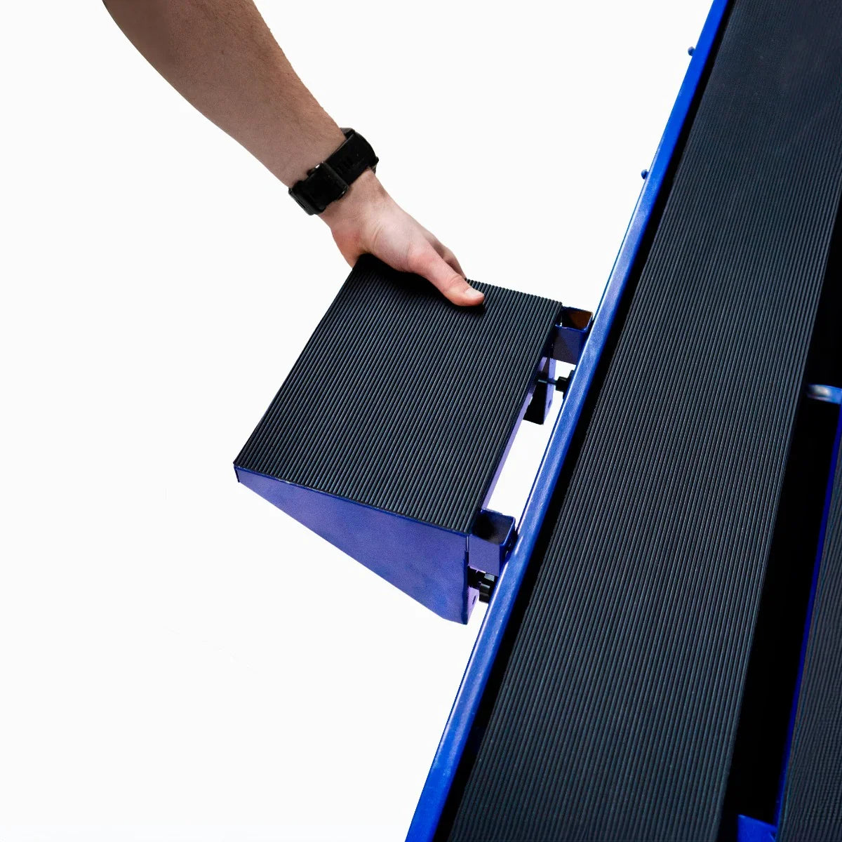 Wet tile cutter bench with a textured black cutting surface, being adjusted by hand, showcasing its sturdy design and functionality