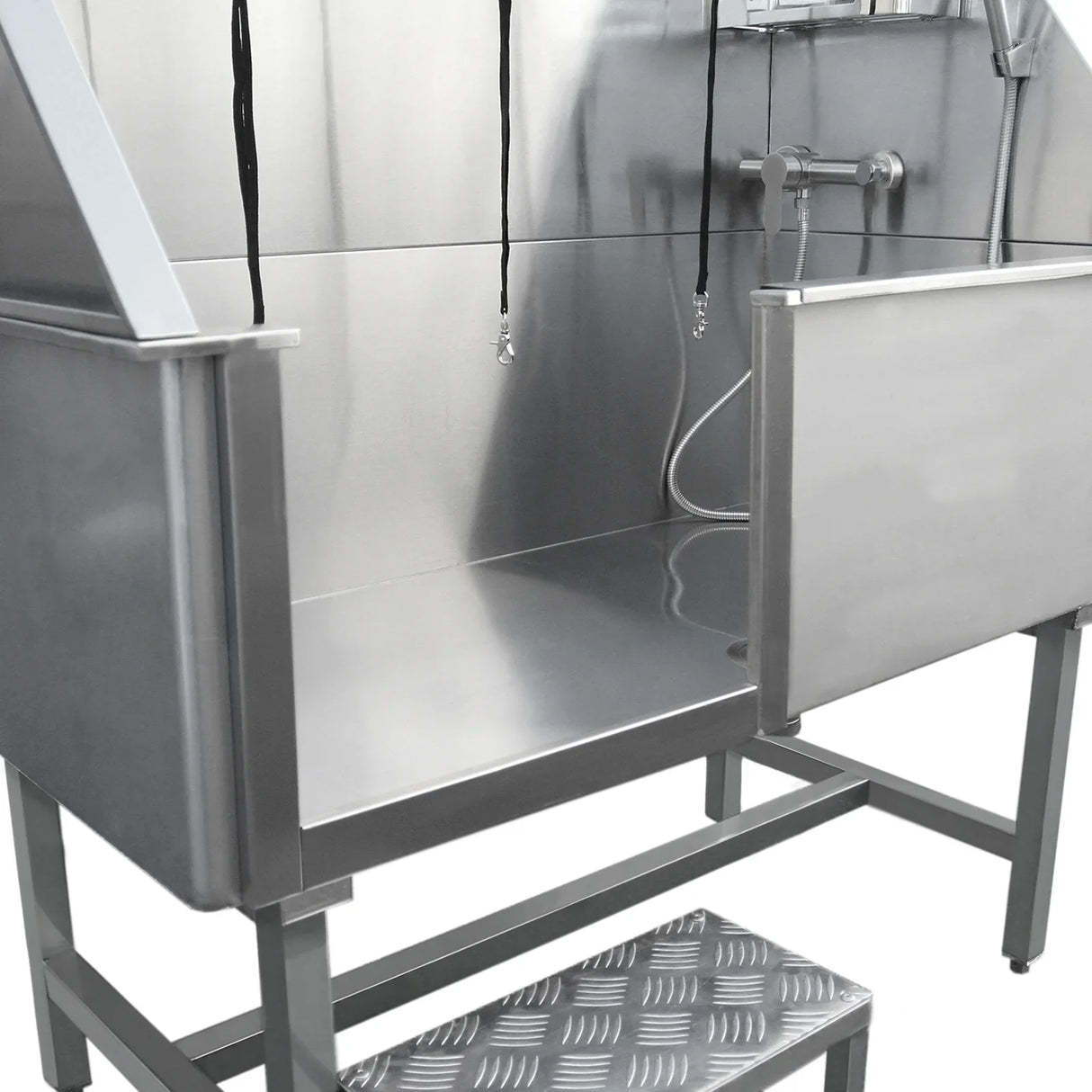 Stainless steel dog grooming bath station with a spacious wash area, adjustable showerhead, and non-slip step for pets