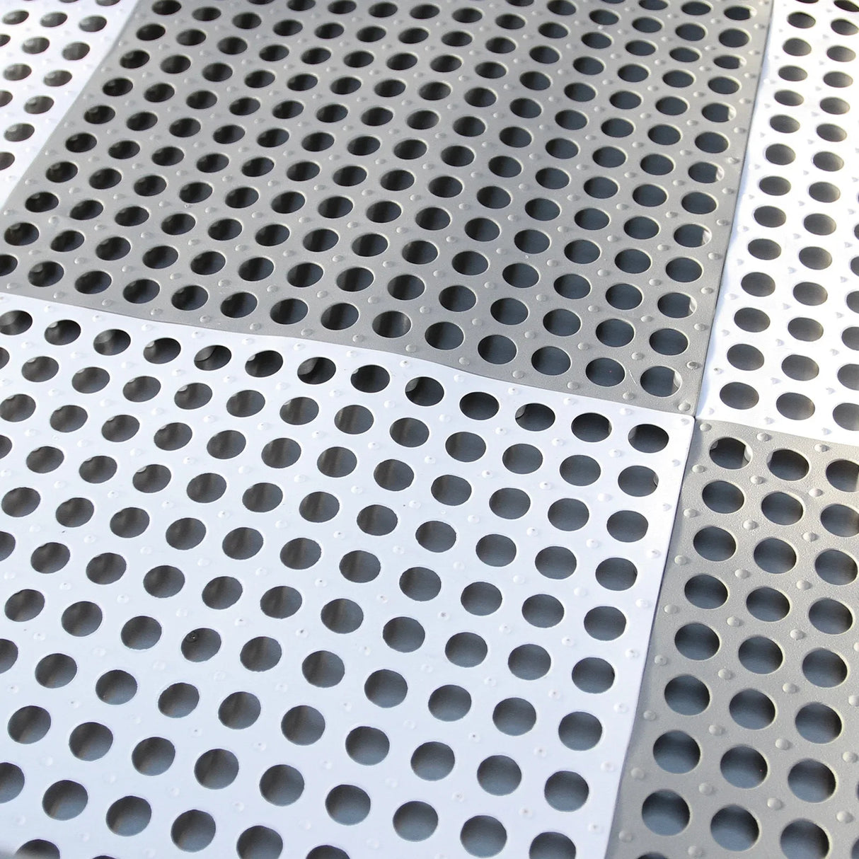 Textured gray rubber mat with circular drainage holes, designed for use in a dog grooming bath wash station, ensuring slip resistance and easy cleaning