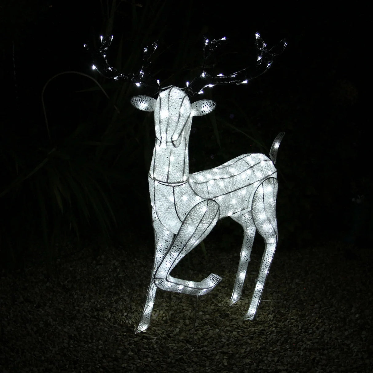 Large light up stag reindeer with a sleek white wireframe design, illuminated by bright white lights, set against a dark background