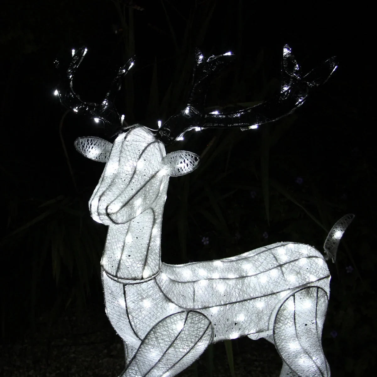 Light up reindeer stag with glowing white lights, intricate mesh design, and antlers, perfect for festive outdoor decorations