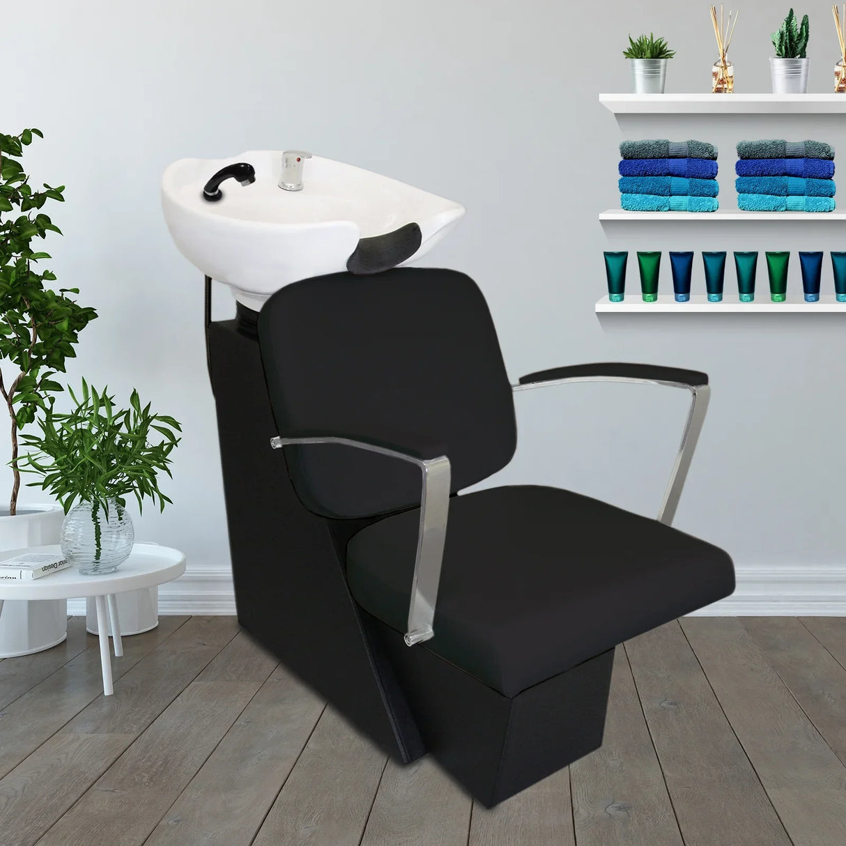 Black salon backwash chair with sleek design, soft upholstery, and integrated sink, perfect for hair washing and styling