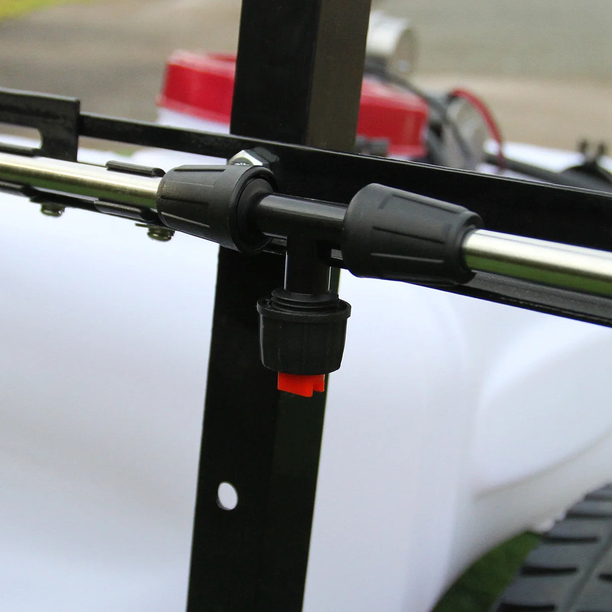 Close-up of the 60L ATV trailer sprayer's nozzle and hose connection, showcasing durable materials and precise fittings for effective spraying