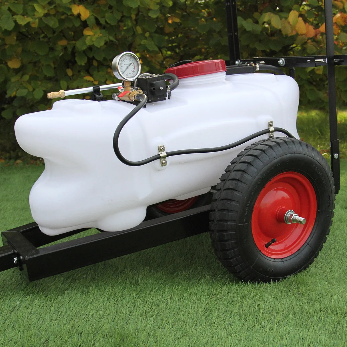 100L ATV trailer sprayer with a white tank, red wheels, pressure gauge, and black frame on green grass background