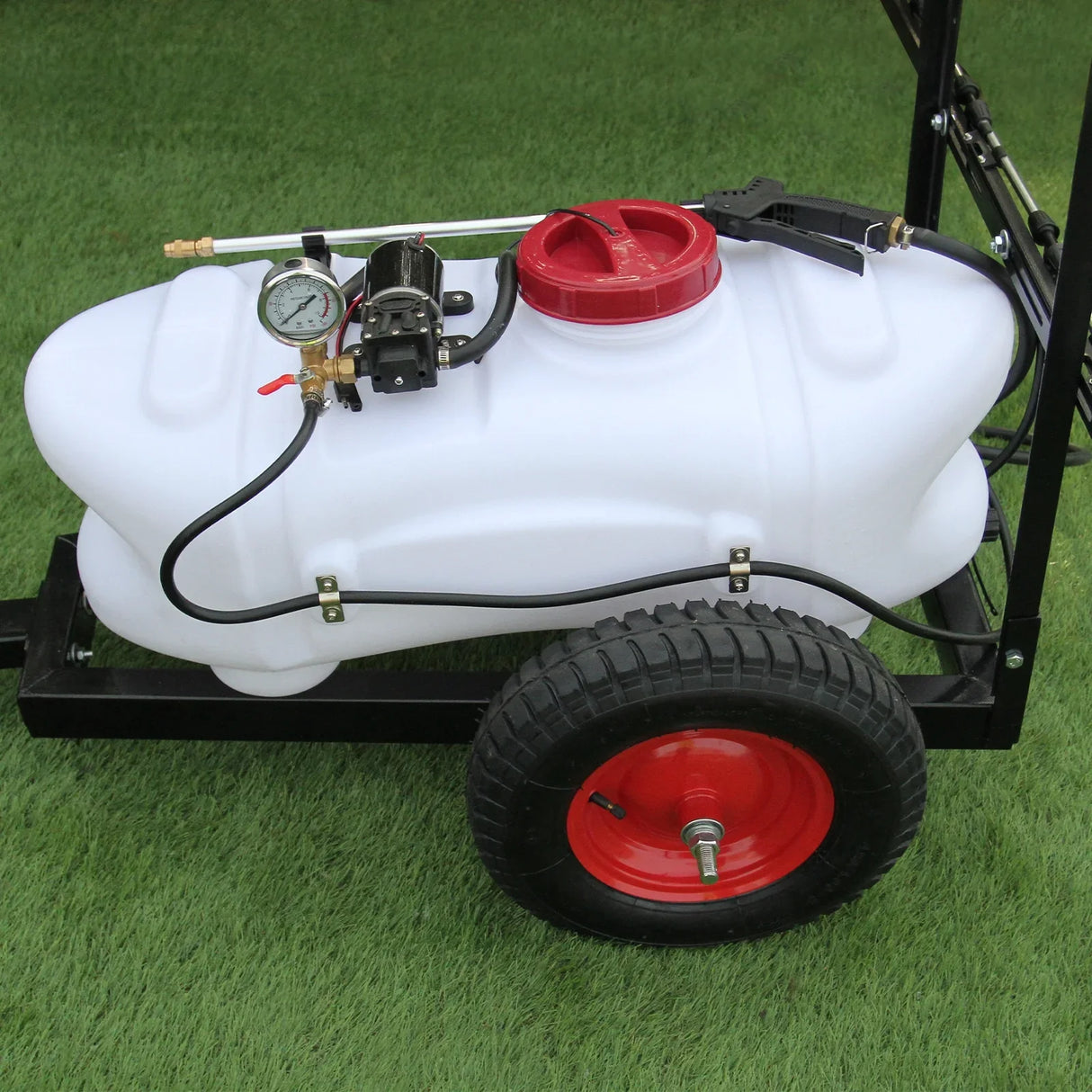 100L ATV trailer sprayer with white tank, red cap, pressure gauge, and sturdy black frame on rubber tire, set on green grass