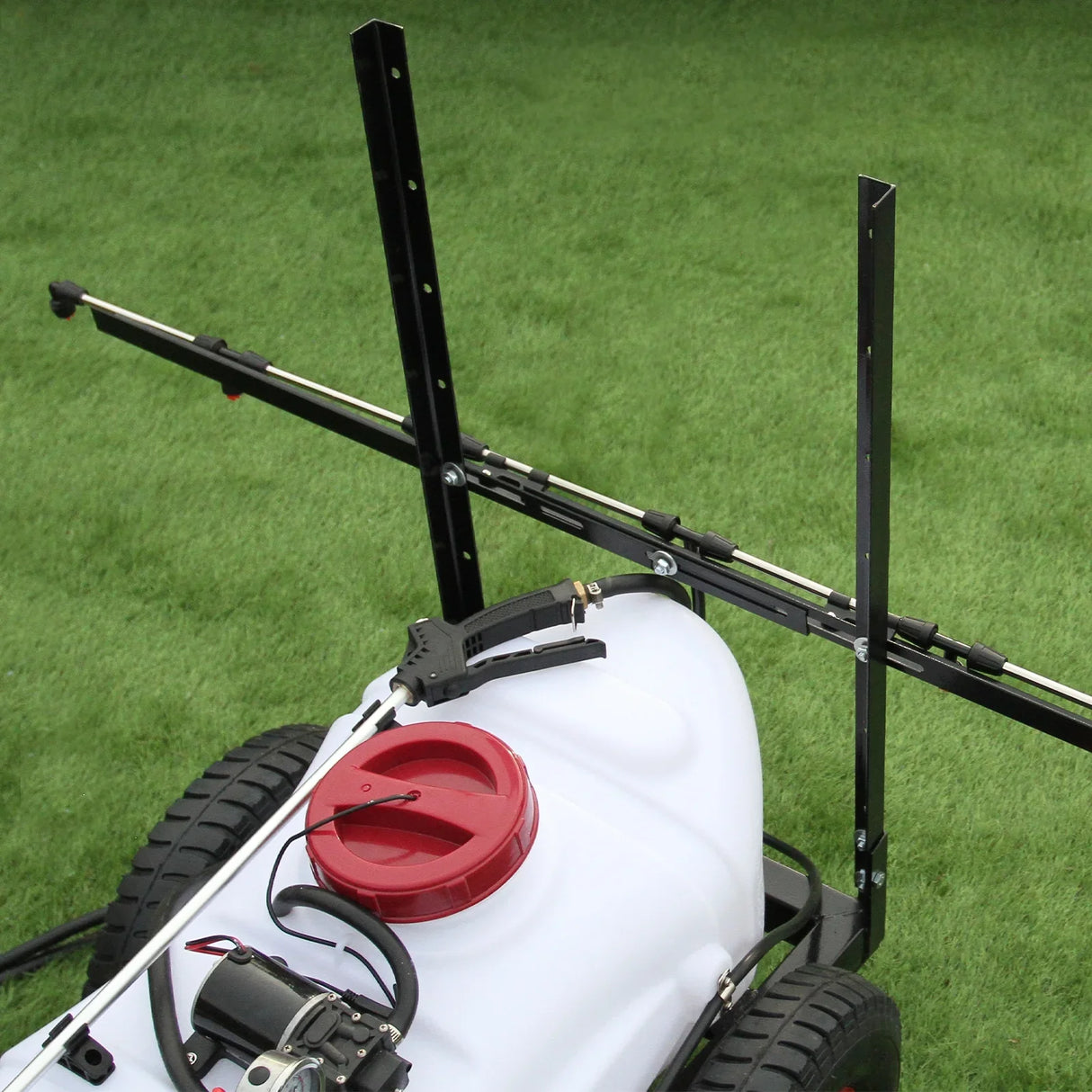 100L ATV trailer sprayer with a white tank, red cap, and adjustable spray boom mounted on a sturdy black frame