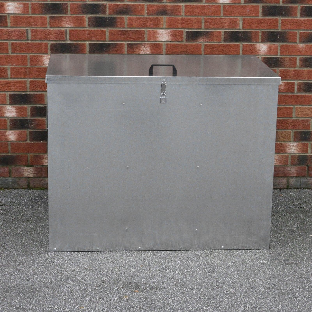 Galvanised feed store with three compartments, featuring a sturdy metal construction, secure latch, and sleek silver finish against a brick background