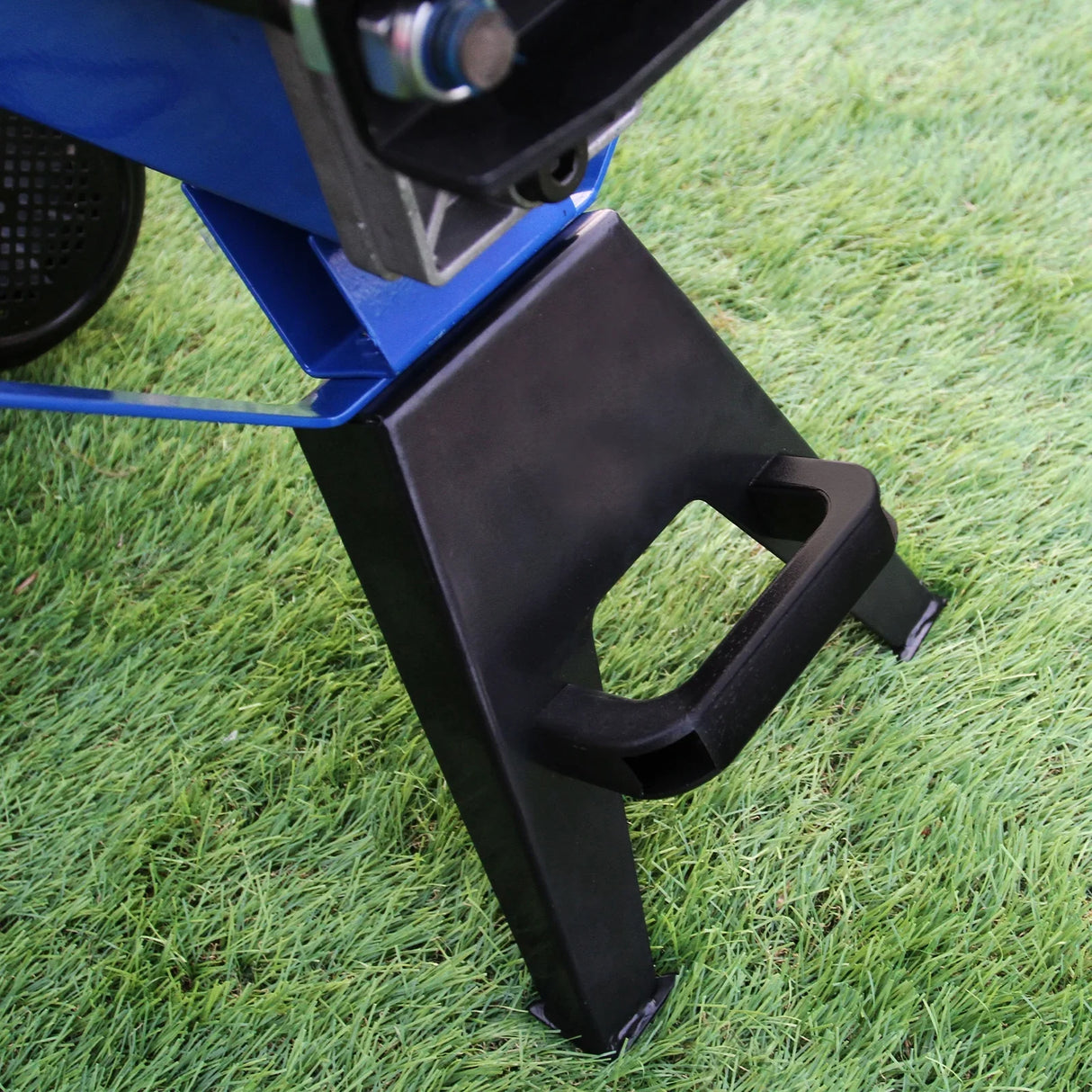 Sturdy black metal base of the T-Mech Log Splitter, featuring a handle for easy maneuverability on grass surface
