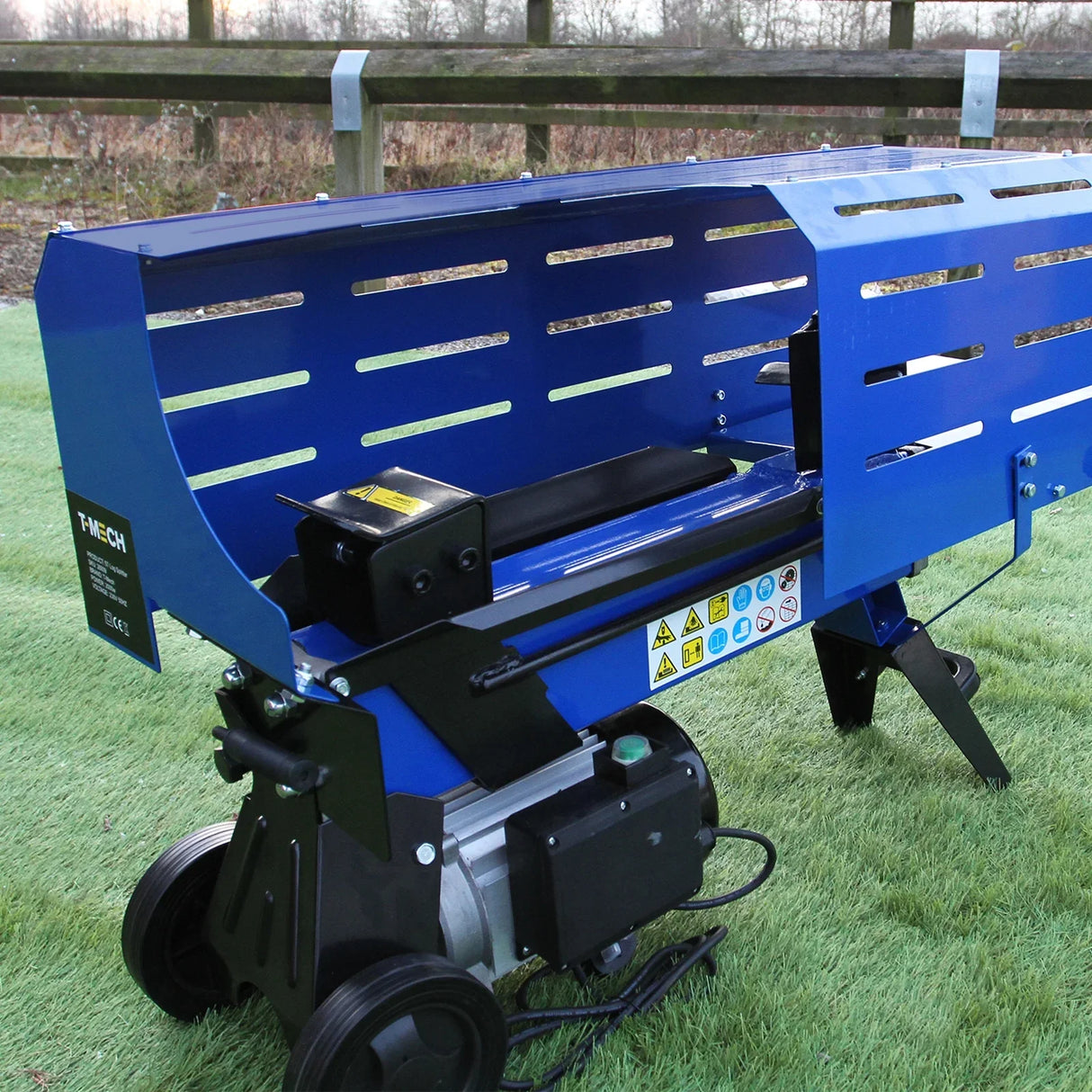 T-Mech 5T log splitter in vibrant blue with a sturdy design, featuring a powerful motor and safety warning labels for efficient wood splitting