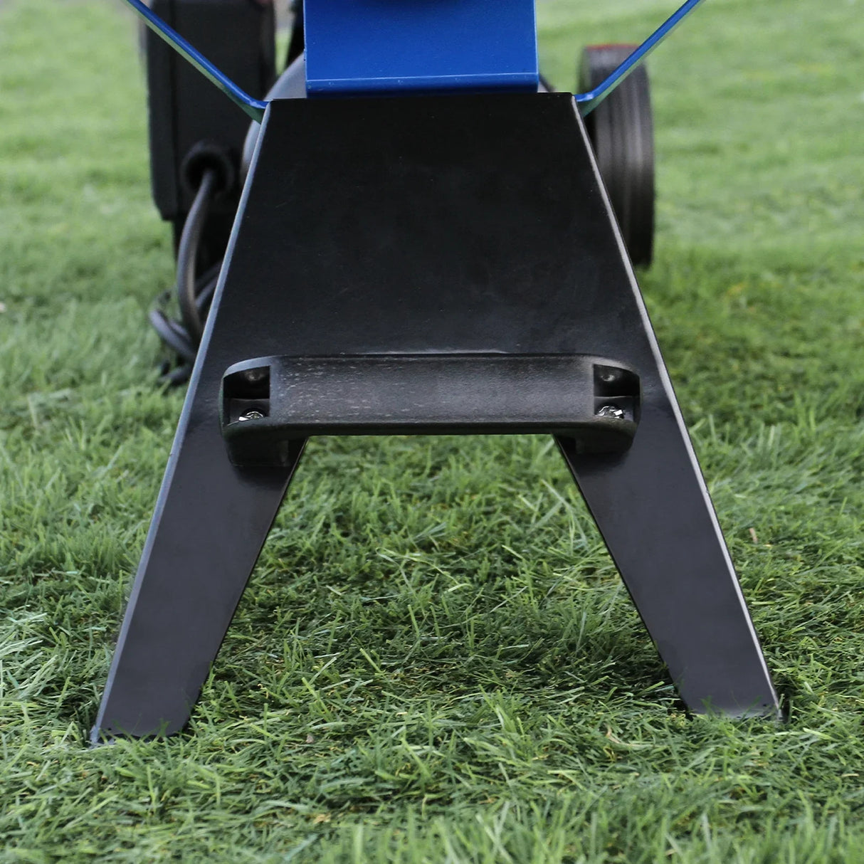 Sturdy black metal base of the T-Mech Log Splitter, featuring a wide stance for stability on grass, with visible mounting points