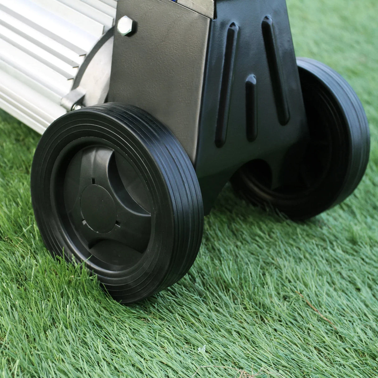Close-up of T-Mech Log Splitter's durable black wheels on grass, showcasing sturdy design for easy mobility and stability