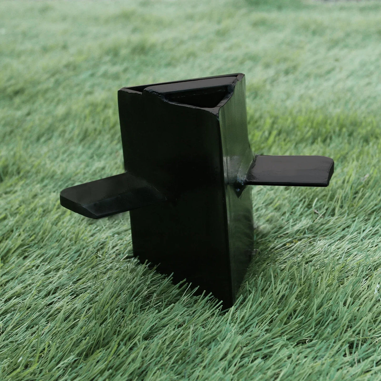 T-Mech 7T Log Splitter with a sturdy black metal frame, featuring a triangular shape and two flat handles for easy operation on grass