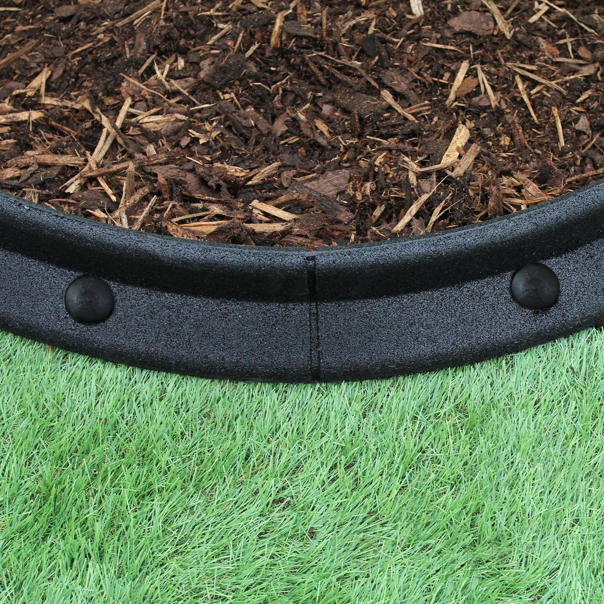 Flexible black lawn edging, 1.2m long, featuring a smooth, curved design with secure connectors, ideal for garden borders and landscaping
