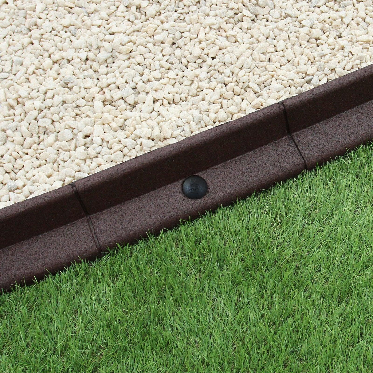 Flexible brown lawn edging 1.2m x 4, featuring a textured surface, neatly separating gravel and lush green grass for a polished look