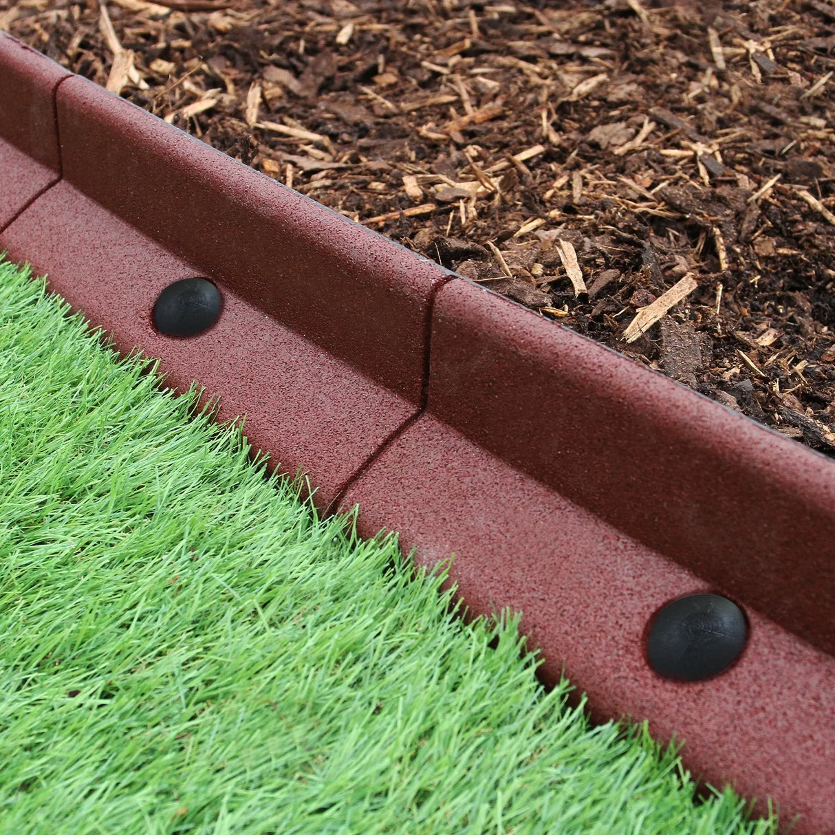 Flexible terracotta lawn edging, 1.2m long, featuring a textured surface, curved shape, and black connectors, ideal for garden borders