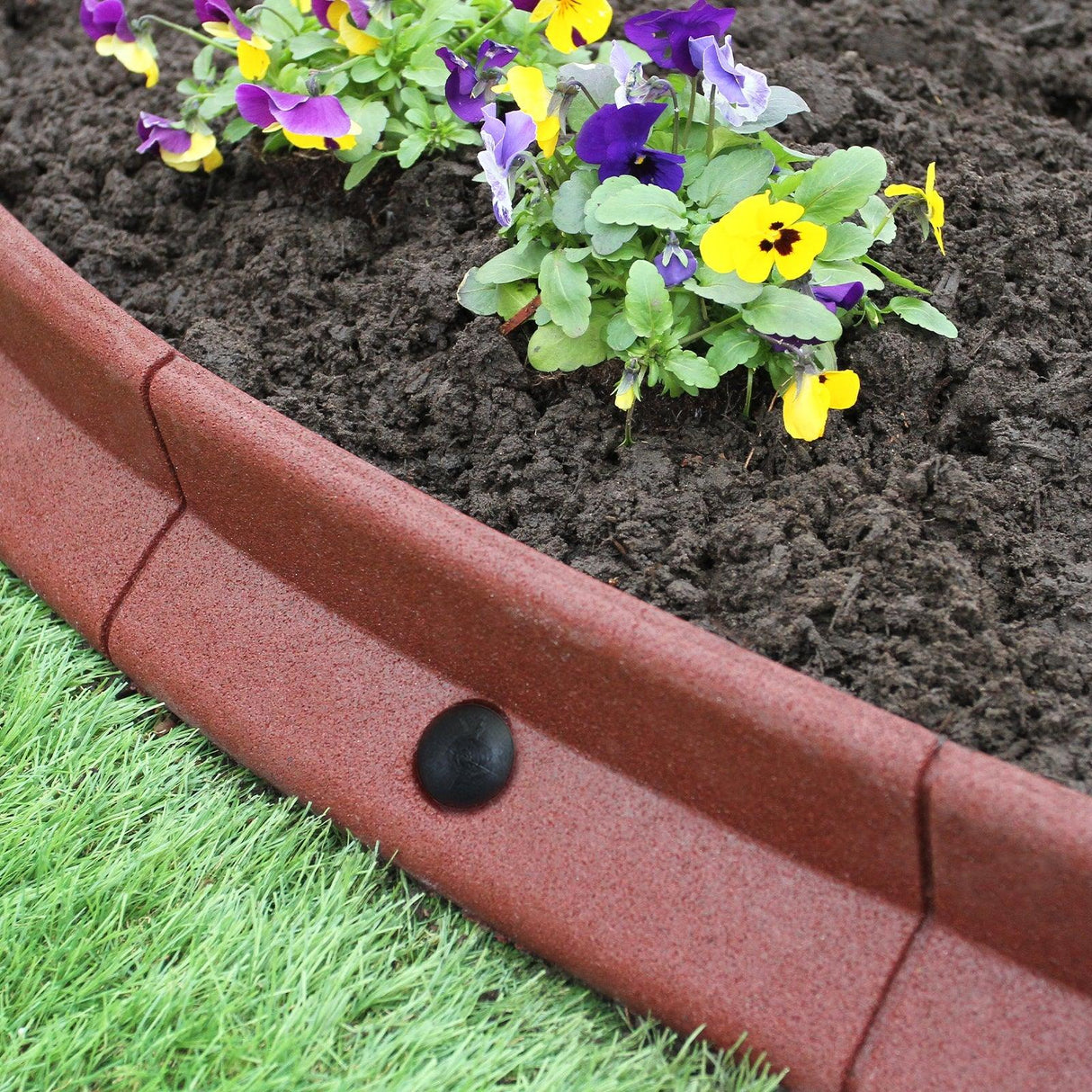 Flexible terracotta lawn edging, 1.2m long, features a smooth texture and curved shape, enhancing garden beds with vibrant flowers