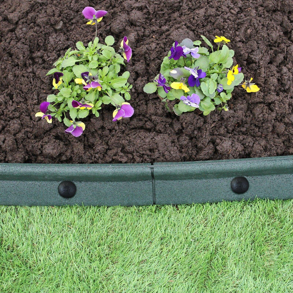 Flexible green lawn edging, 1.2m long, showcasing vibrant flowers in rich soil, enhancing garden design and organization