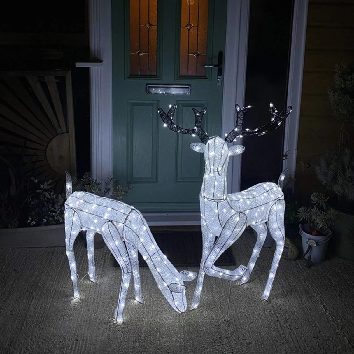 Large light-up stag and doe reindeer set with white LED lights, featuring a sleek design and festive glow, perfect for holiday decor