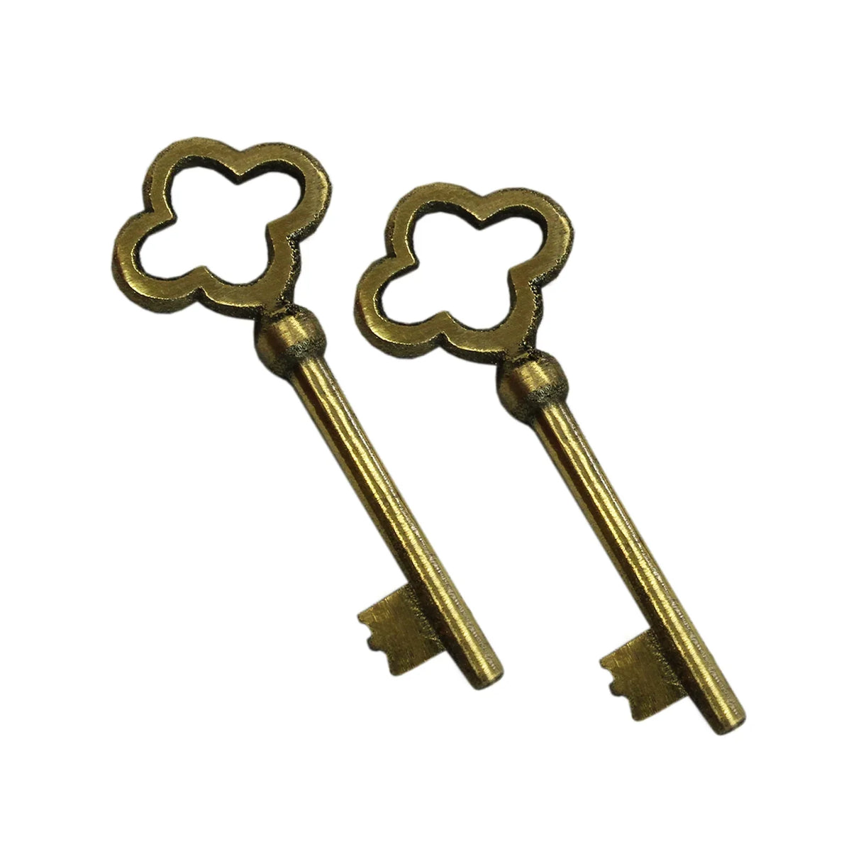 Antique-style brass keys with a decorative clover-shaped bow and a long shaft, ideal for vintage-inspired decor or collections