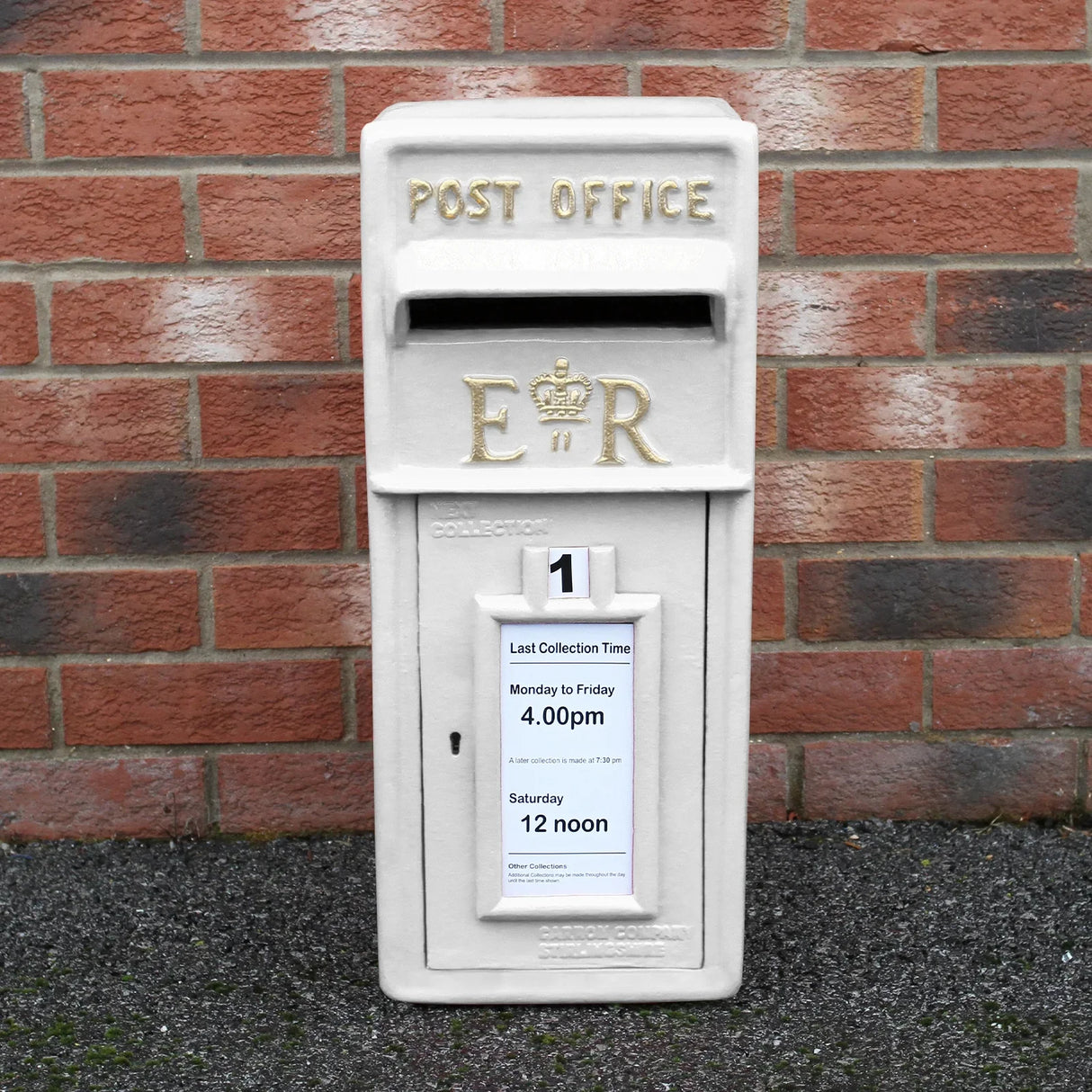 White Royal Mail post box with stand, featuring a textured white finish, gold lettering, and a collection time notice attached