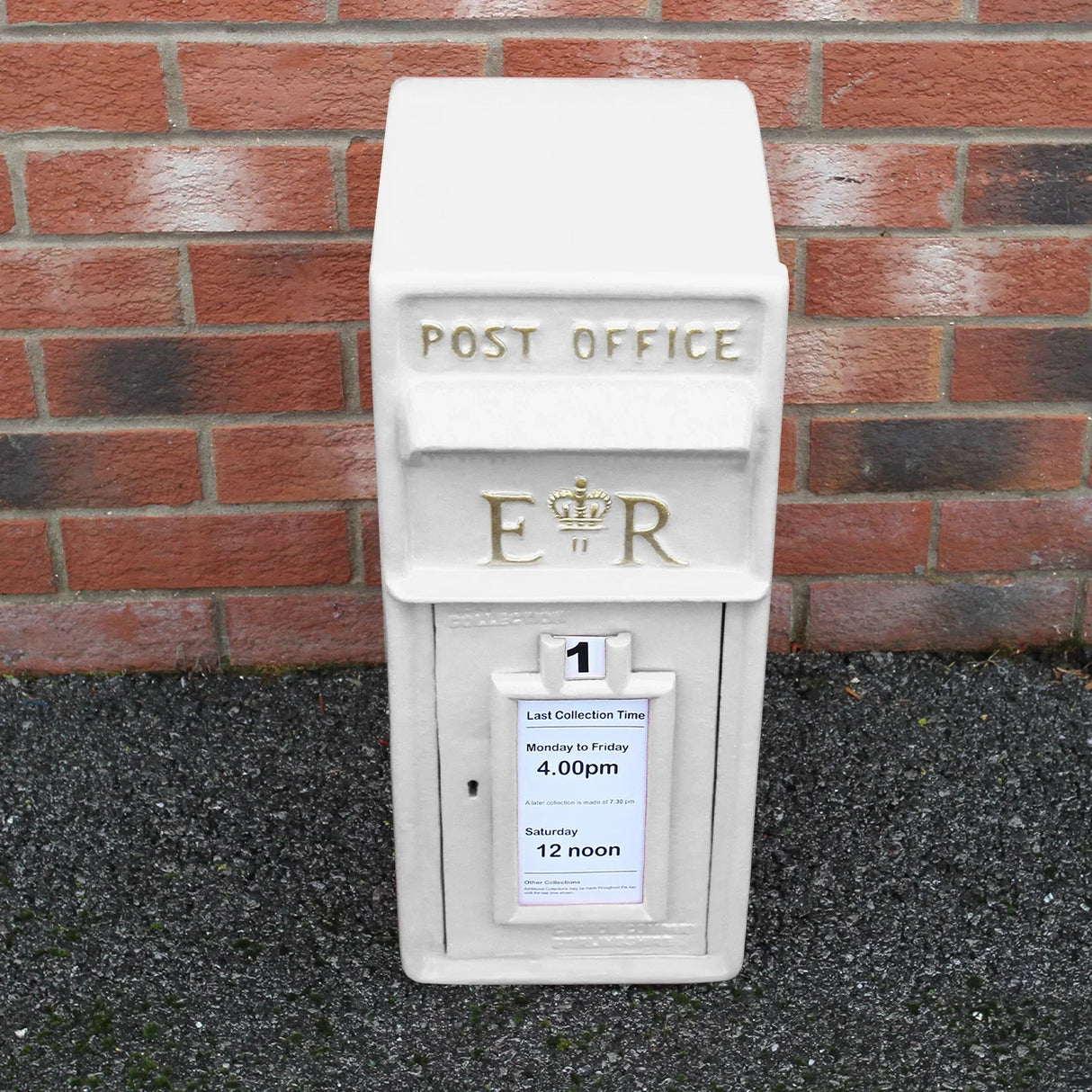 White Royal Mail post box with a textured white finish, featuring gold lettering, collection times, and a crown emblem