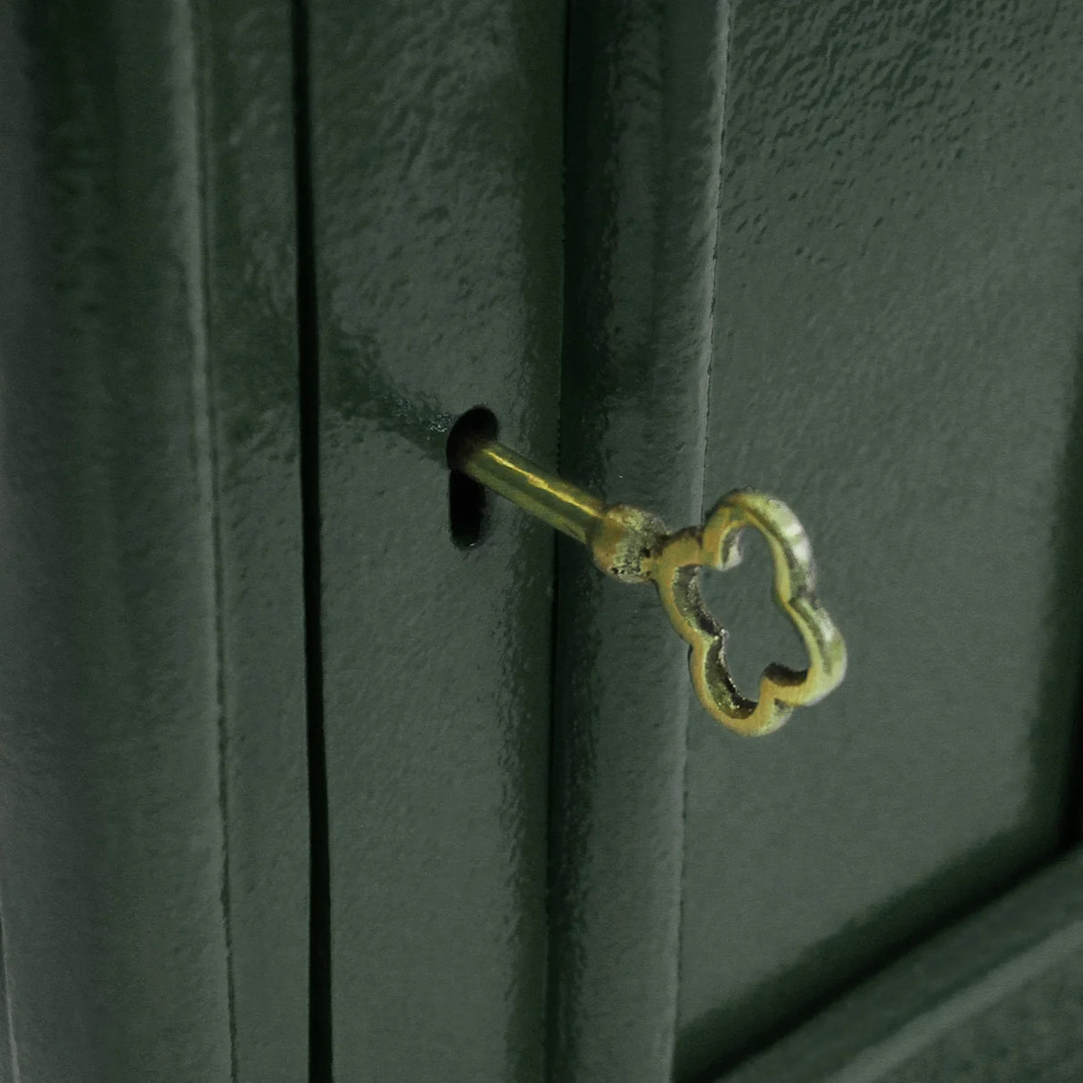 Green Irish post box with a decorative shamrock keyhole, featuring a glossy finish and sturdy metal construction