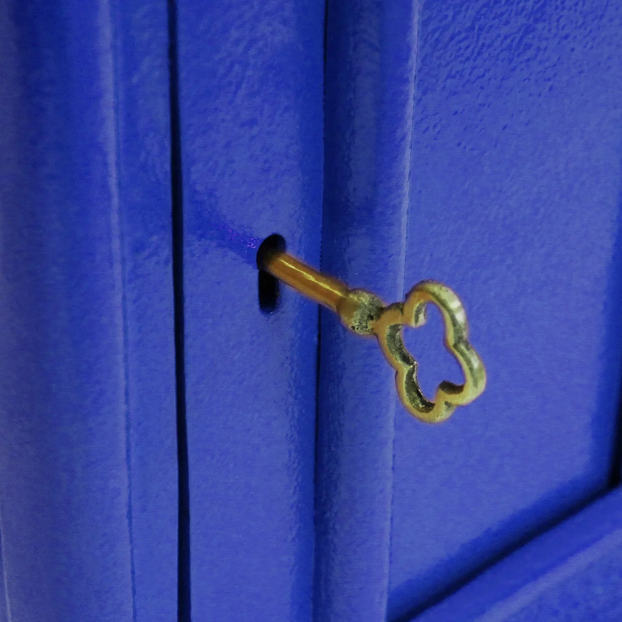 Bright blue Scottish post box featuring a decorative keyhole, showcasing a smooth finish and classic design elements