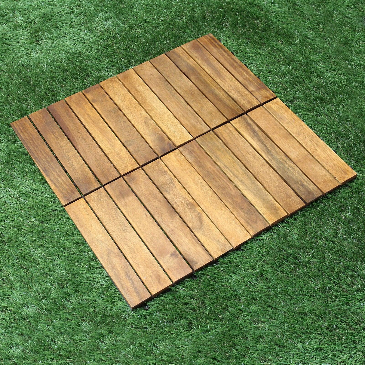 Natural wood decking tiles arranged in a square pattern, showcasing rich brown tones and smooth texture on green grass background