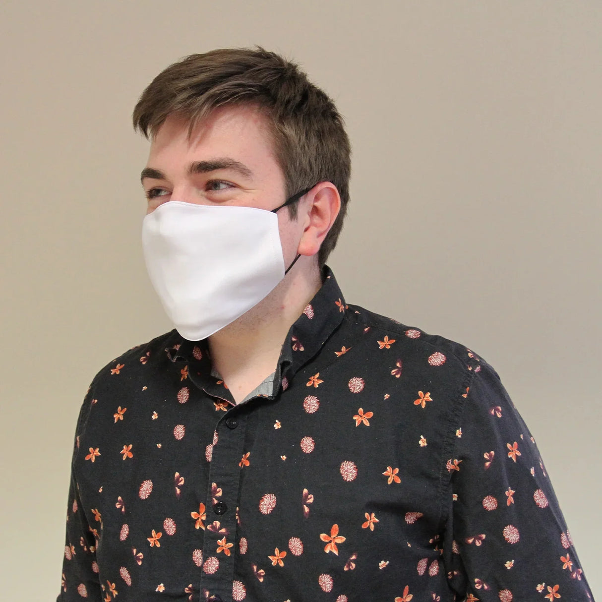 Large white sublimation blank face mask worn by a man, showcasing a smooth fabric texture and adjustable ear loops, ideal for custom designs