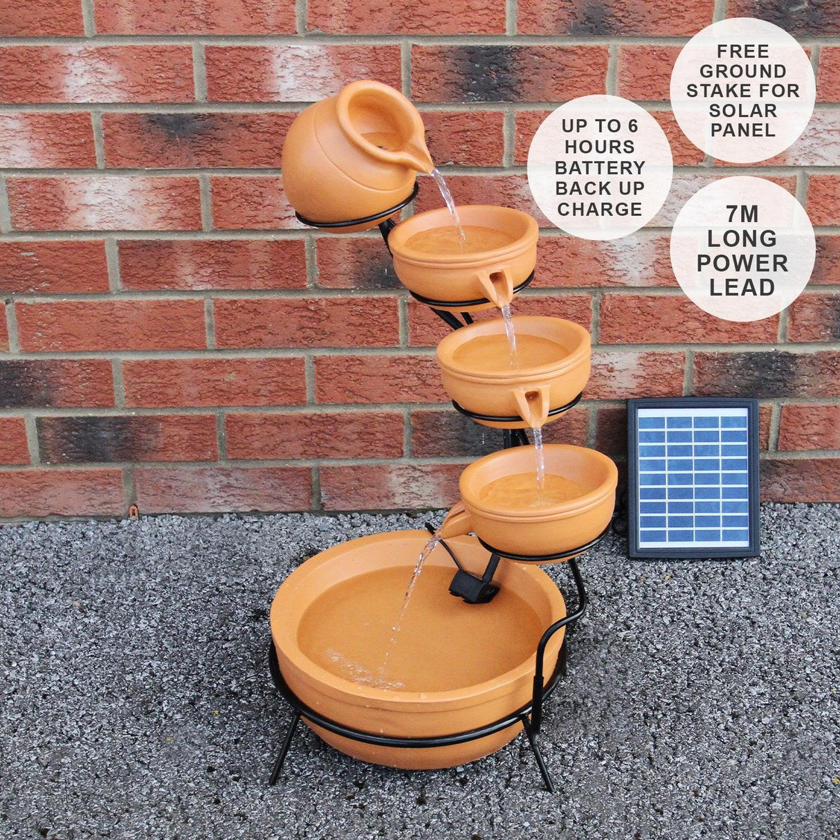 Terracotta 4 tier spilling bowls water feature with a solar panel, showcasing earthy tones and flowing water for a tranquil garden accent