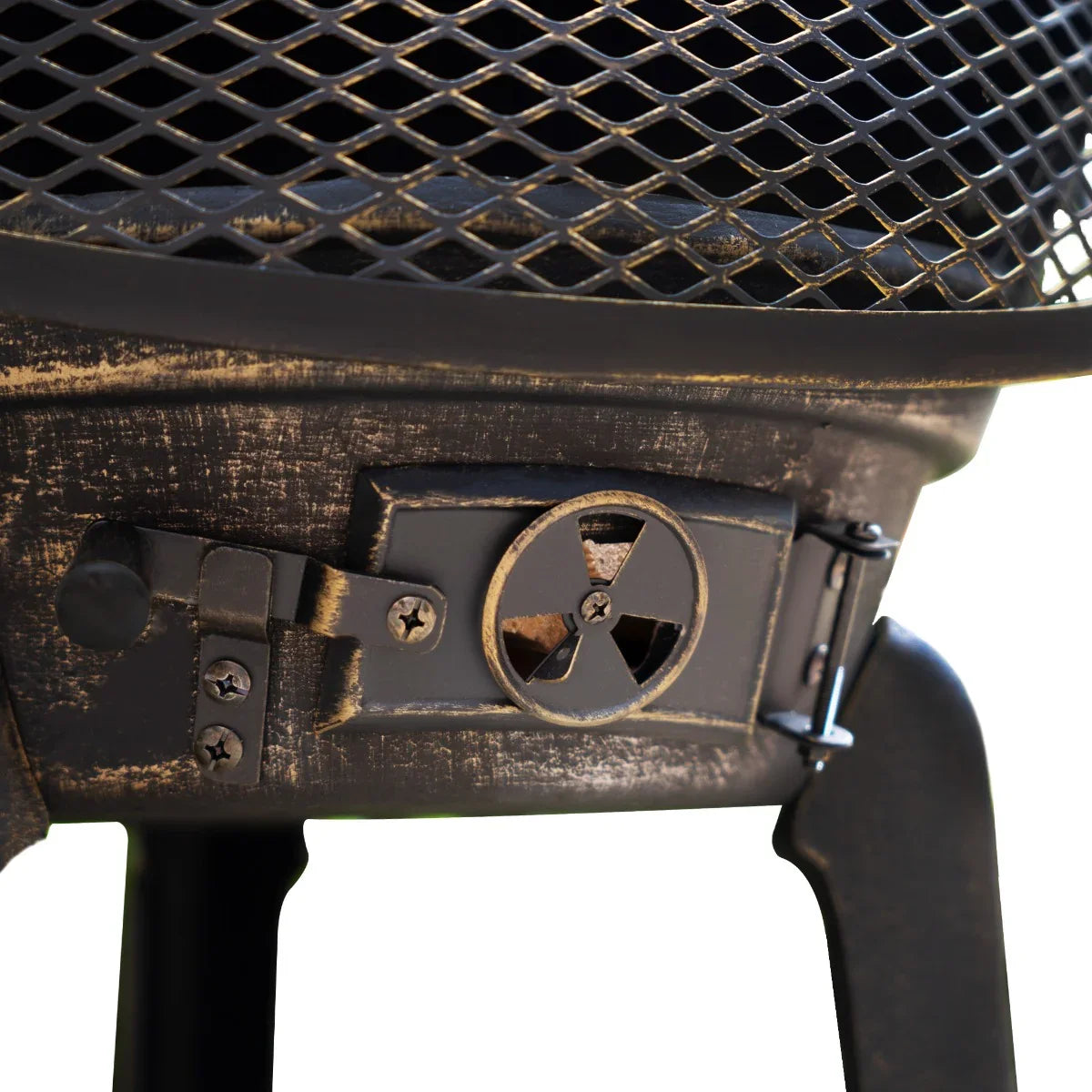 Rustic cast iron chiminea featuring a textured black finish, mesh screen, and a sturdy base with a decorative latch mechanism