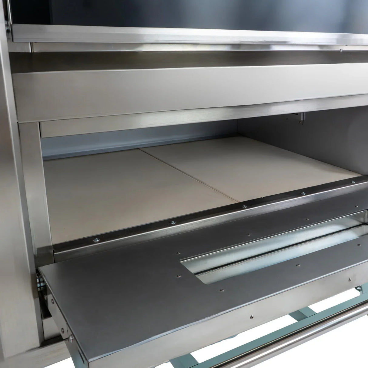 Large commercial pizza oven interior with two ceramic baking stones, stainless steel finish, and adjustable temperature controls