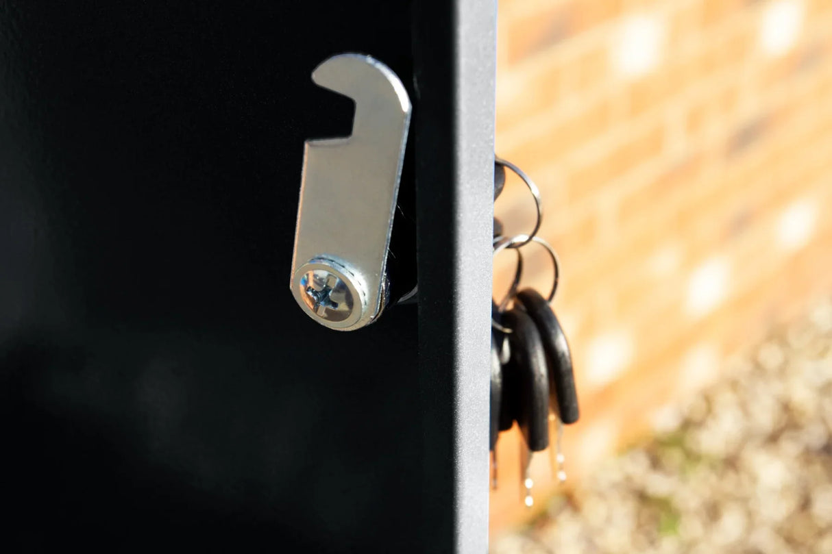 Close-up of a black parcel post box featuring a shiny metal latch and attached keys, showcasing its durable design and security features