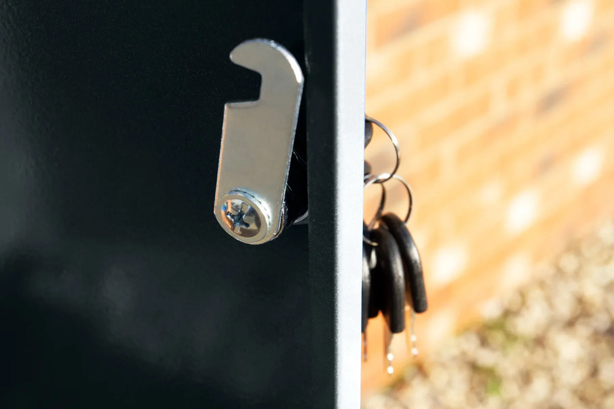 Close-up of a grey parcel post box showing a shiny metal latch and keys hanging from a hook, highlighting its secure design