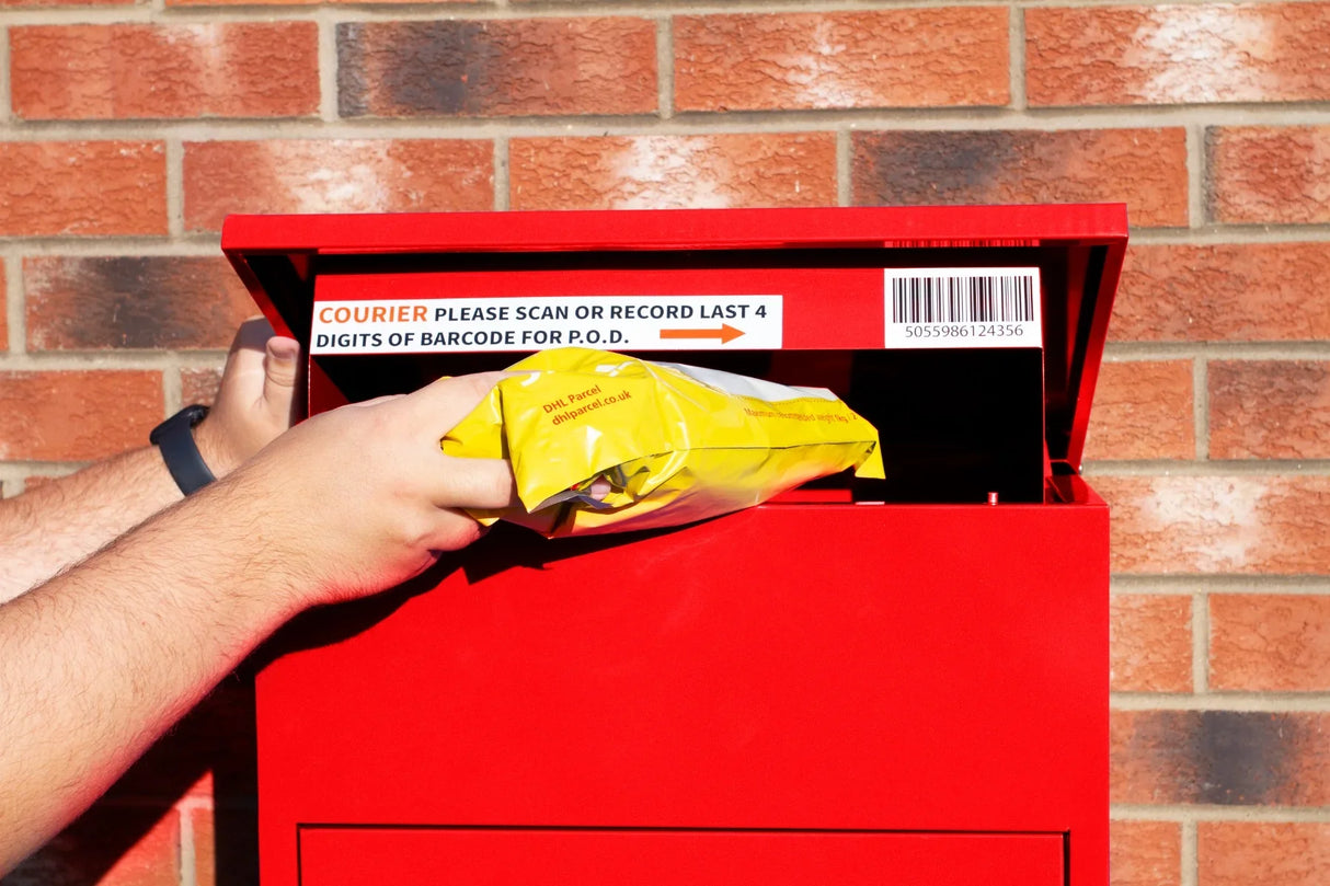 Bright red parcel post box with a hand inserting a yellow package, featuring a barcode and instructions for courier scanning