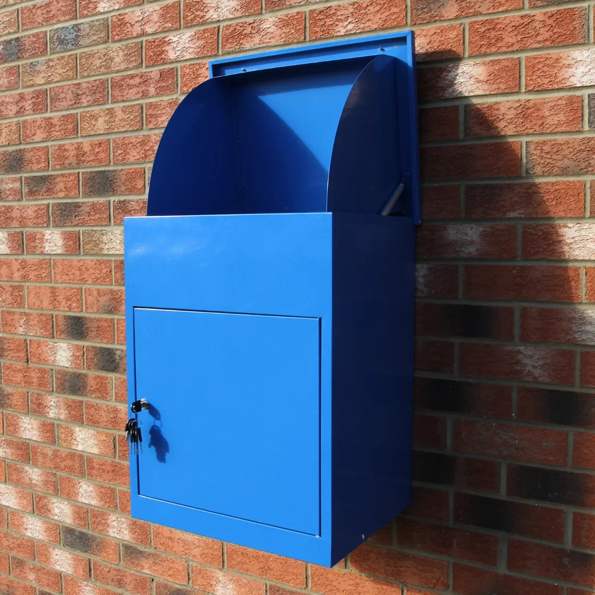 Bright blue parcel post box mounted on a brick wall, featuring a curved top, secure lock, and a spacious drop slot for packages