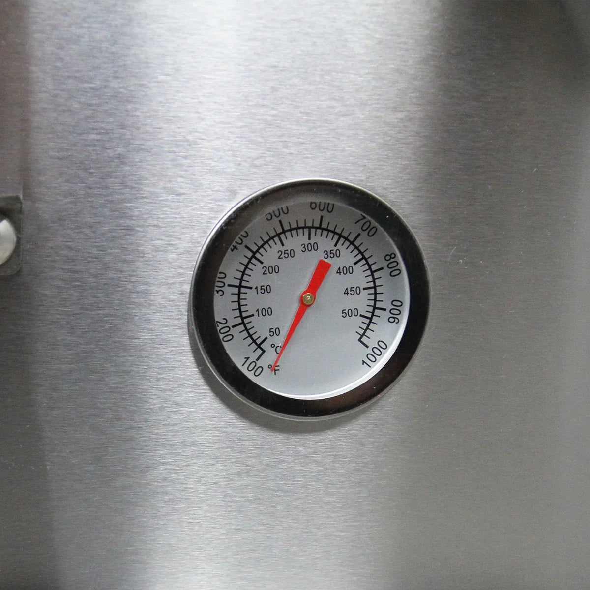 Stainless steel outdoor pizza oven temperature gauge with a red needle, displaying Fahrenheit and Celsius readings for precise cooking