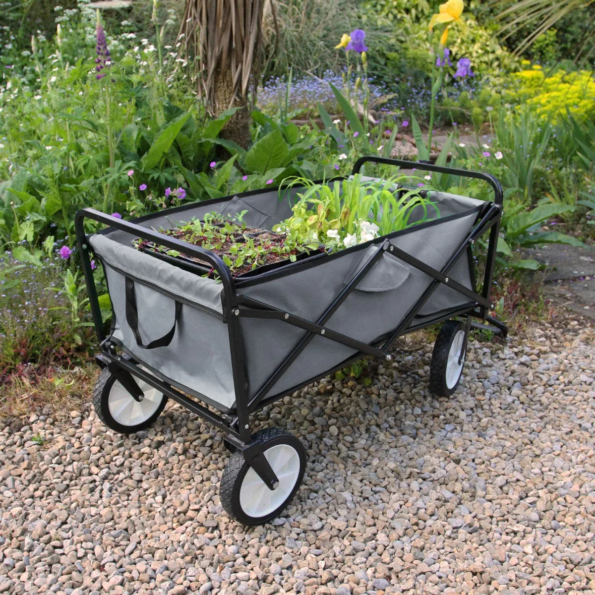 Foldable garden cart in grey with a sturdy black frame, large fabric container, and two wheels, ideal for transporting plants and gardening supplies