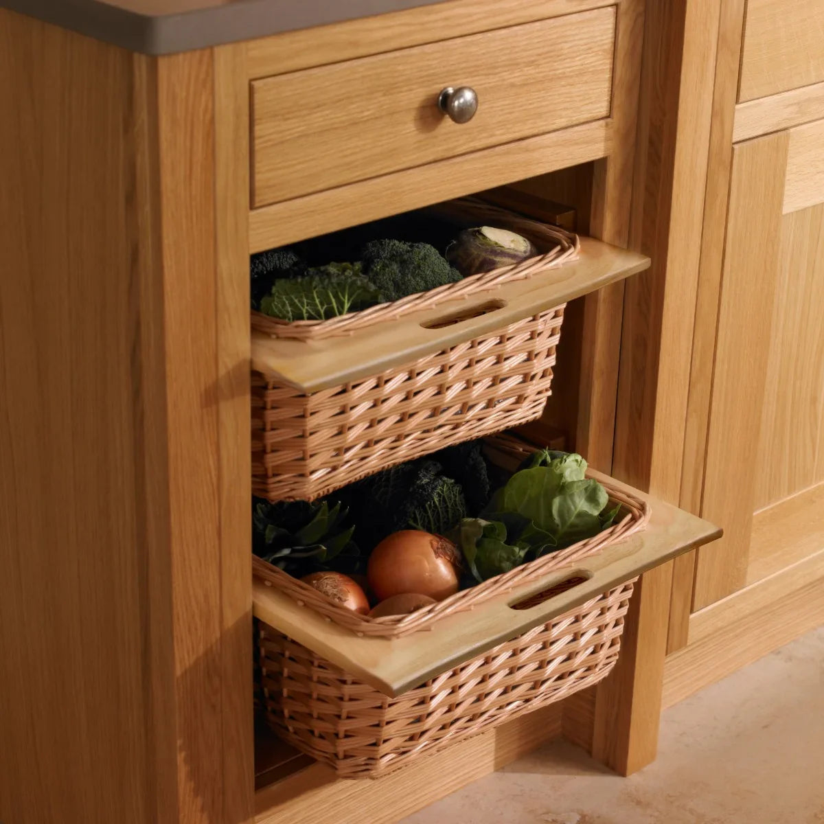 Pull out wicker kitchen baskets in natural tones, showcasing fresh vegetables, nestled in a wooden cabinet with a smooth countertop