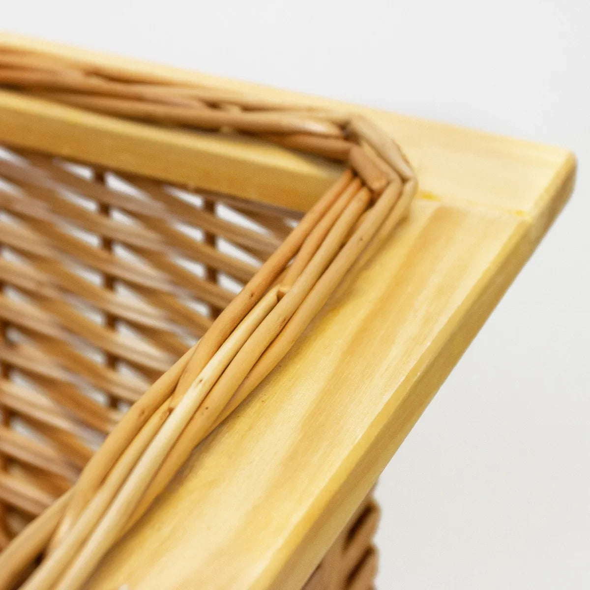 Wicker kitchen basket with a natural wood frame, featuring a woven design and smooth edges, perfect for organized storage