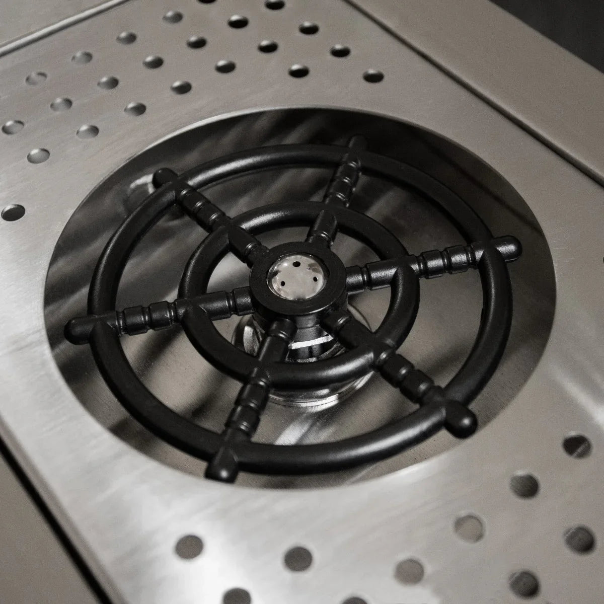Black cast iron burner on stainless steel surface of KuKoo Double Cocktail Bar Station, designed for efficient cooking and mixing
