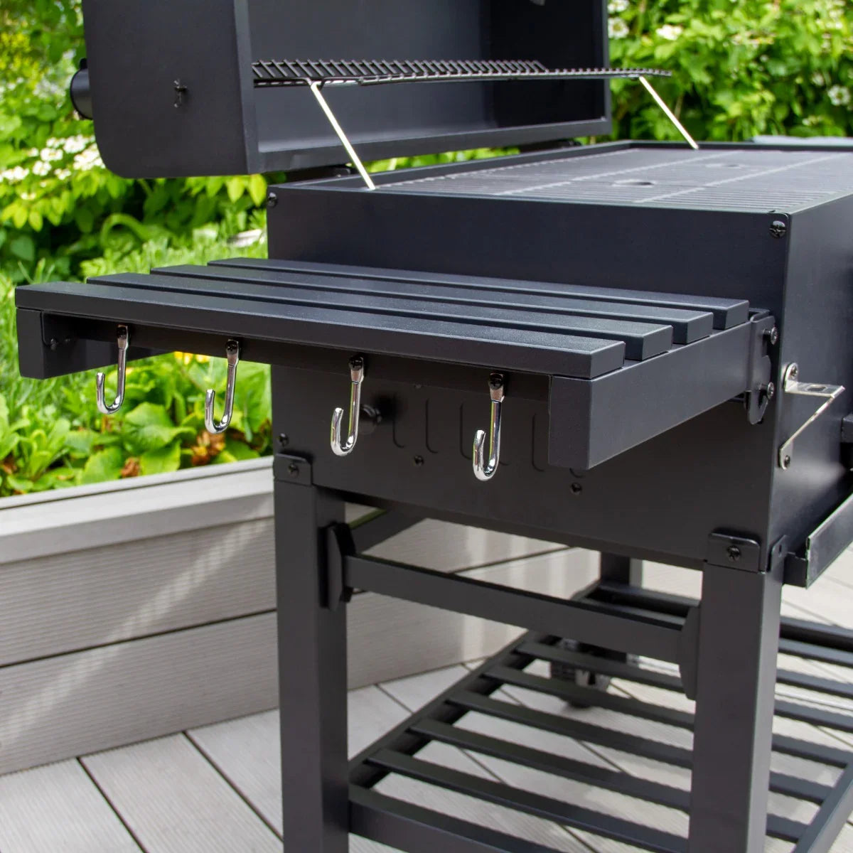 XXL BBQ Smoker with a sturdy black metal body, side shelf with hooks, and a spacious cooking area for outdoor grilling