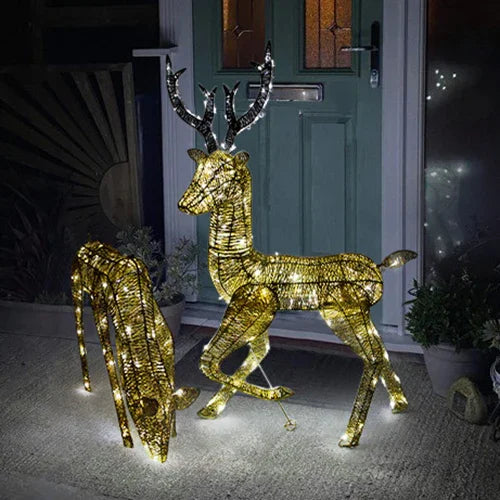 Gold stag and doe set illuminated with warm white lights, featuring intricate wire design and elegant antlers, perfect for festive decor