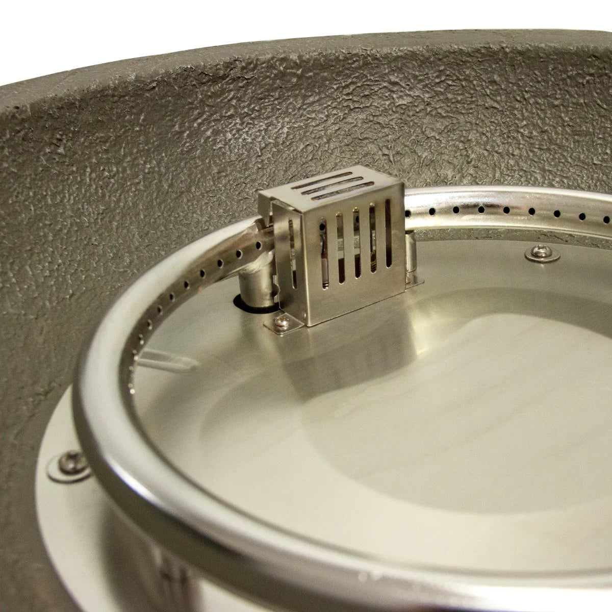 Stainless steel burner inside a round stone gas fire pit heater with a textured gray finish and polished rim for outdoor use